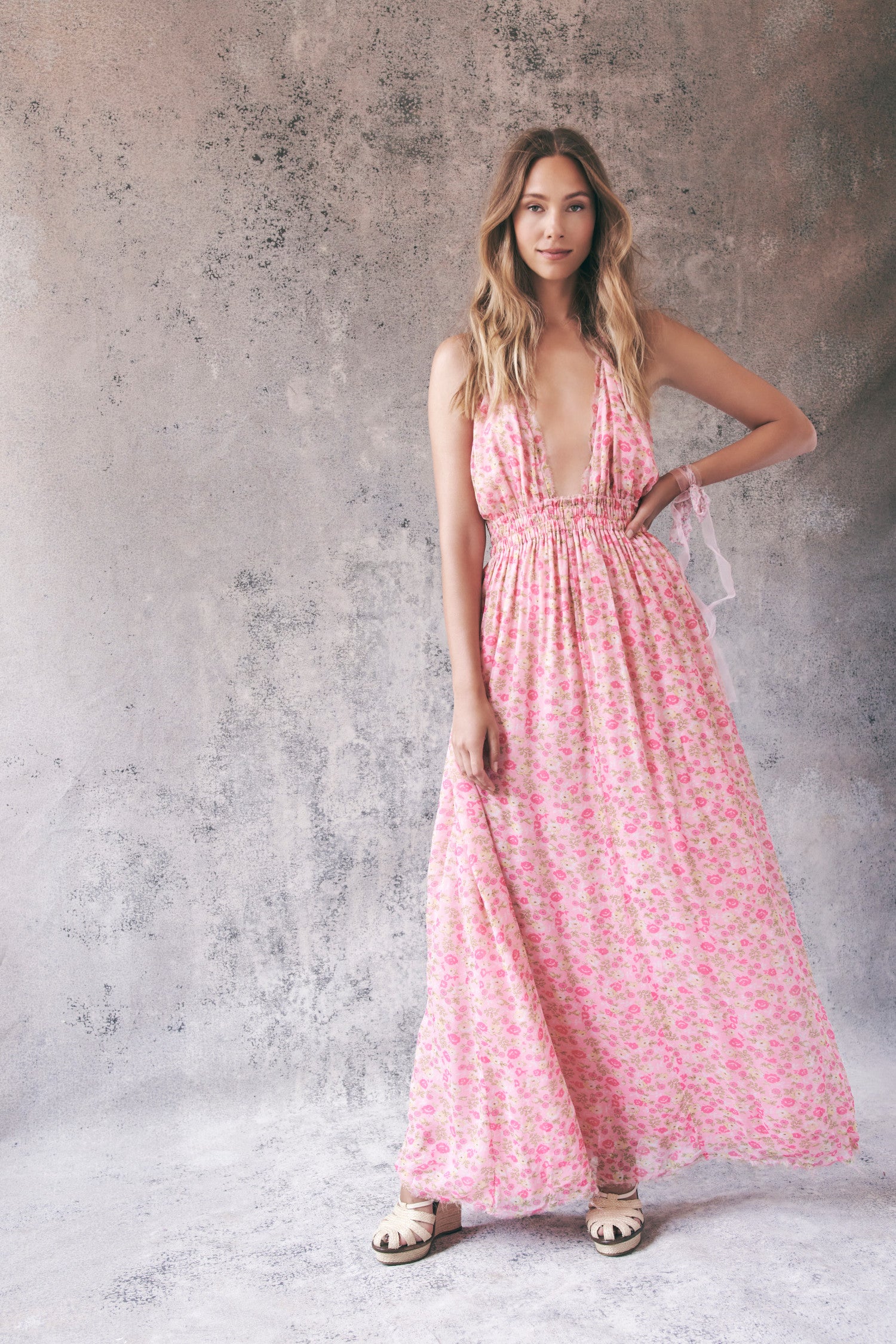 Model wearing pink floral halter maxi dress