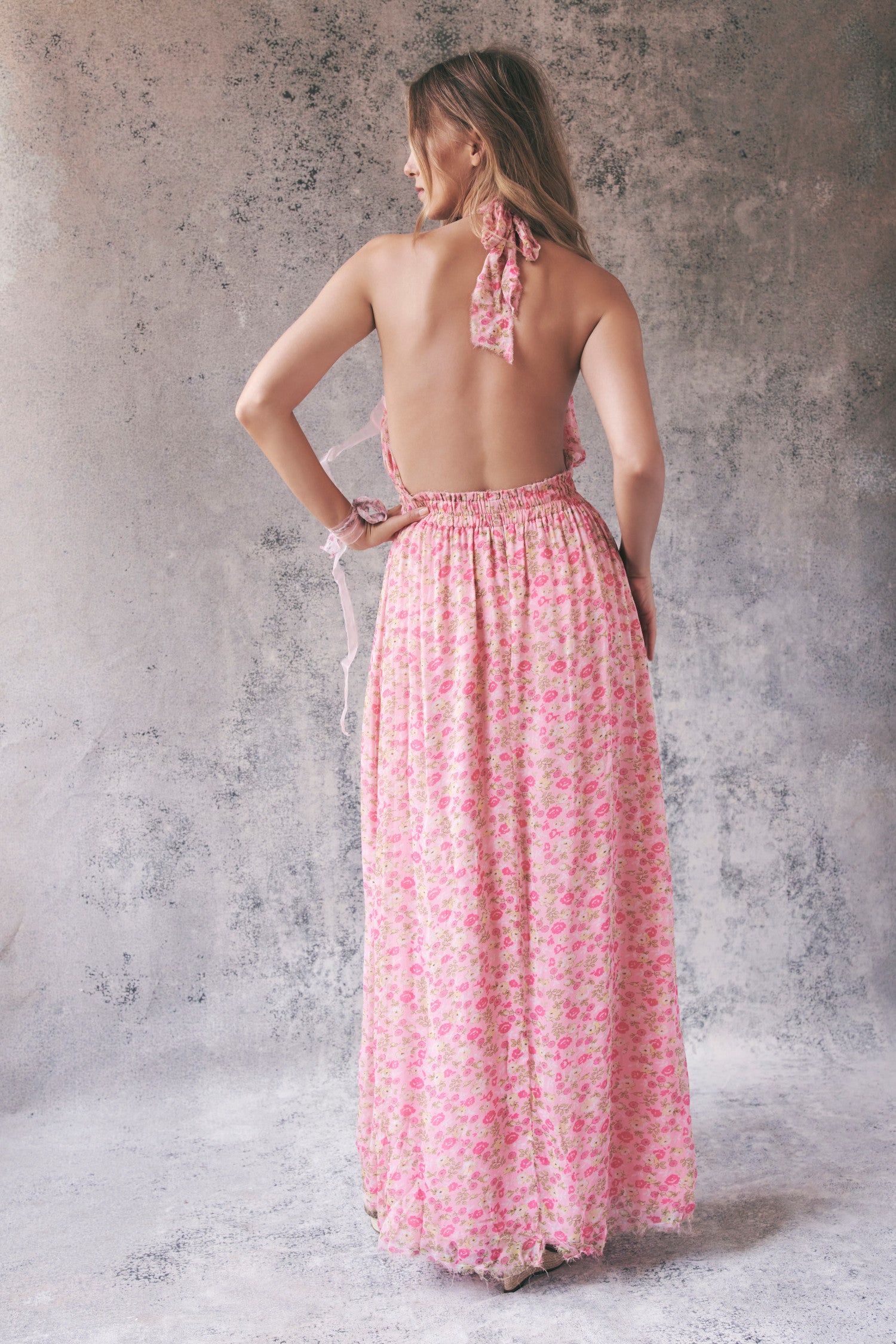 Back image of pink floral halter maxi dress with low back