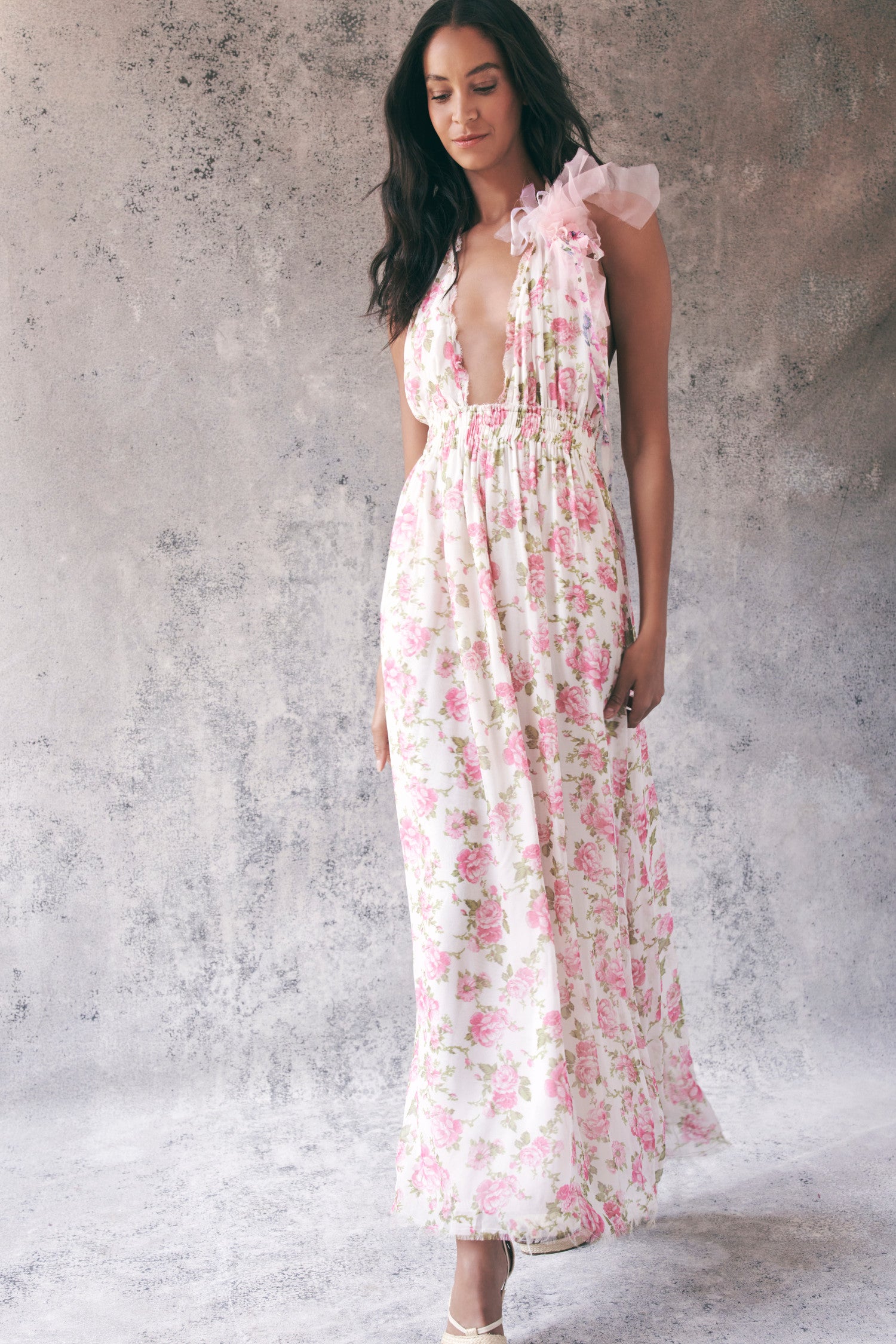 Model wearing pink floral halter maxi dress