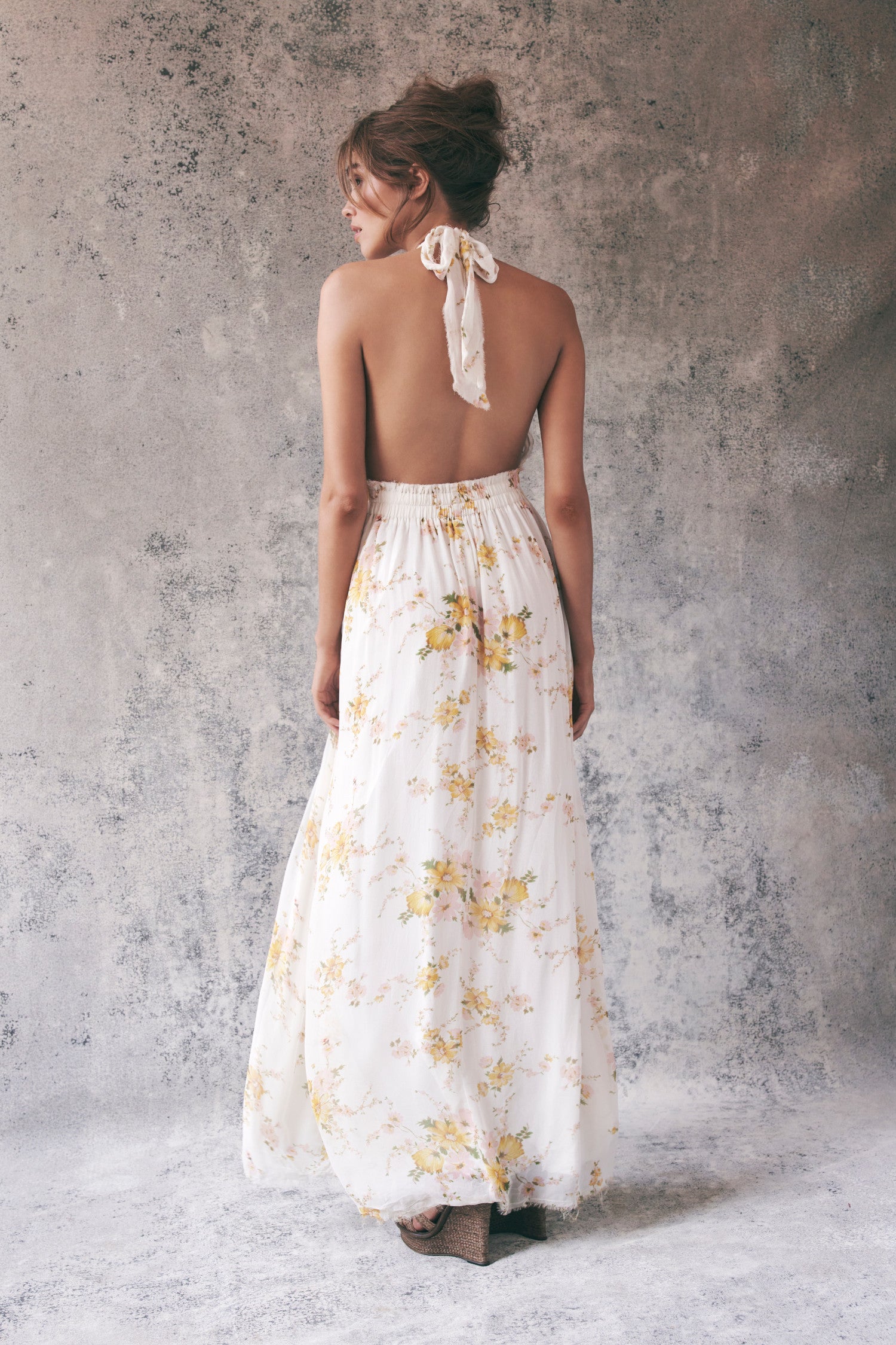 Back image of white and yellow floral halter maxi dress