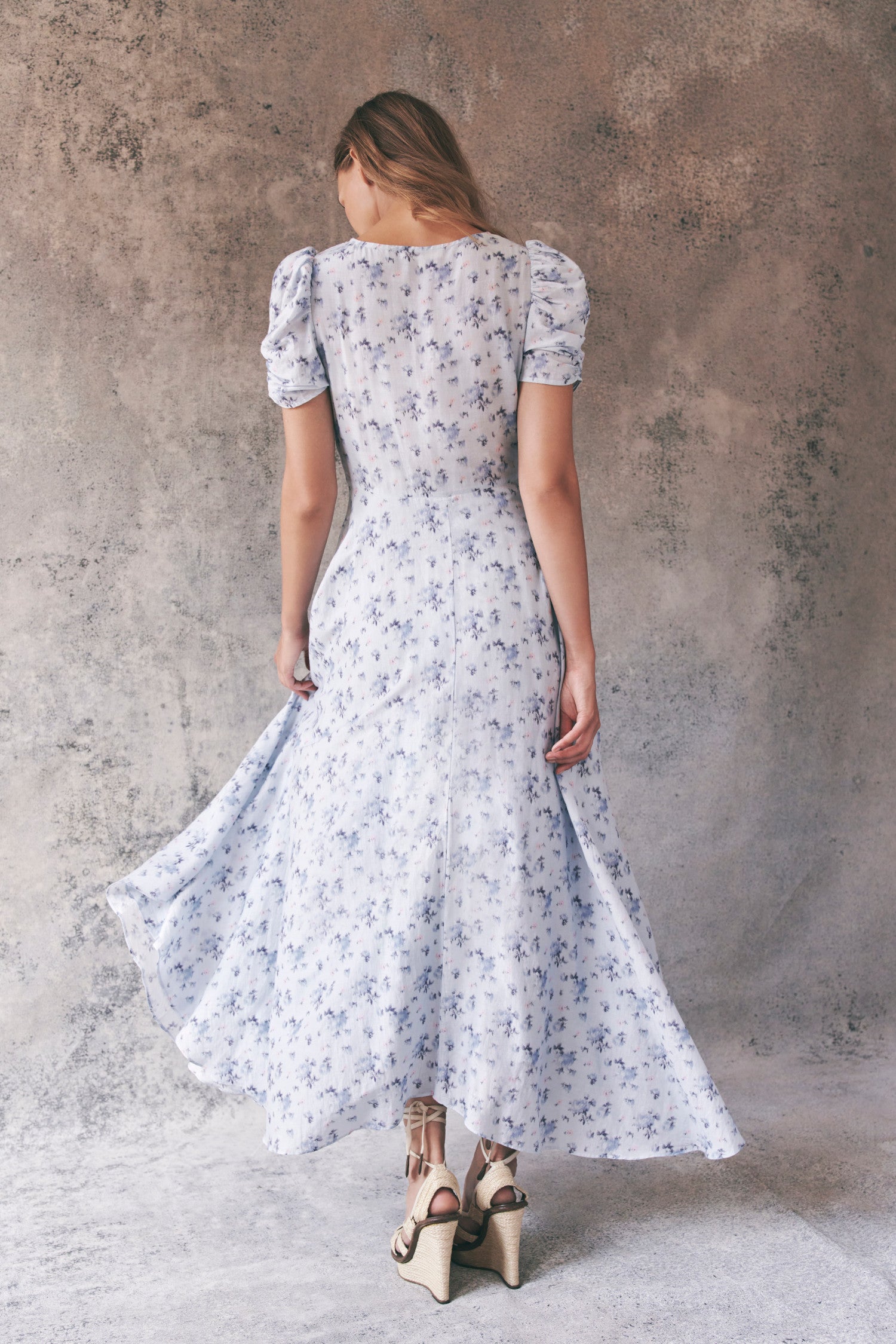 Back image of model wearing blue floral maxi dress