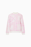 Pink and white patterned sweater on a white background