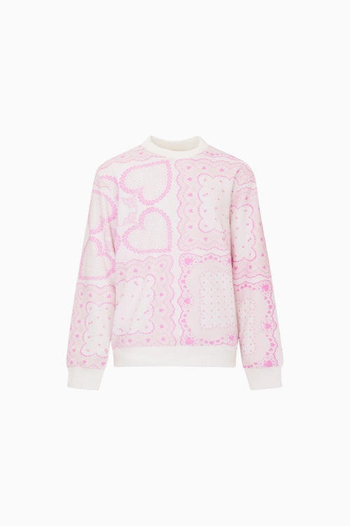 Pink and white patterned sweater on a white background