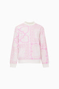 Pink and white patterned sweater on a white background