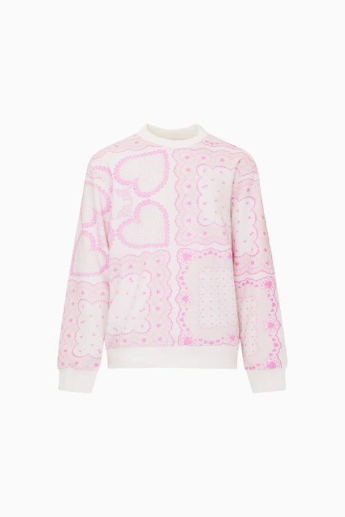Pink and white patterned sweater on a white background