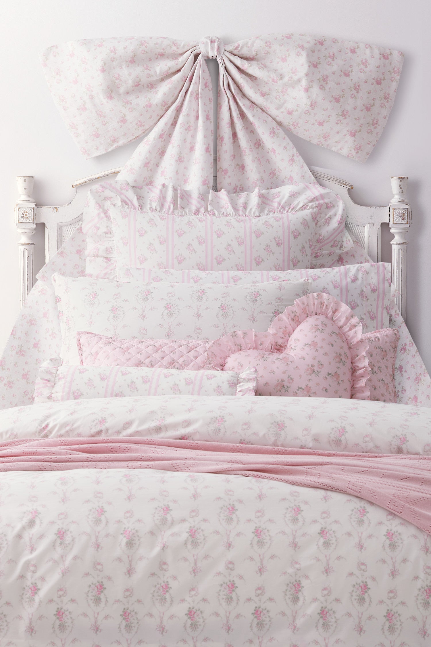Pink, 100% cotton chic throw blanket. Featuring heart and bow-stripped pointelle details. 