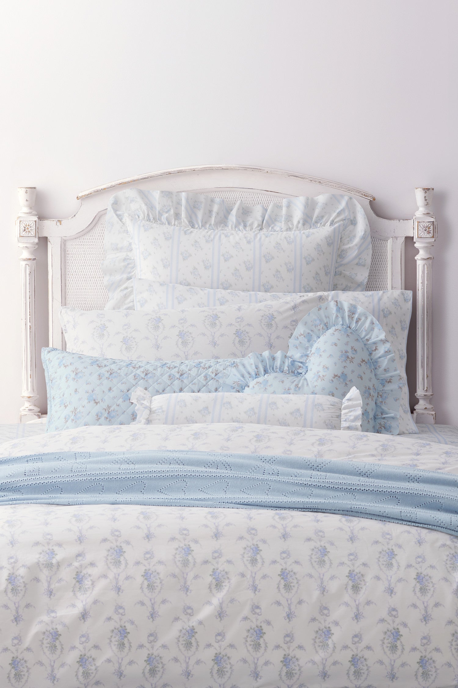 This dreamy ensemble features a delicate blue floral pattern on a pristine white backdrop. Crafted from 100% cotton