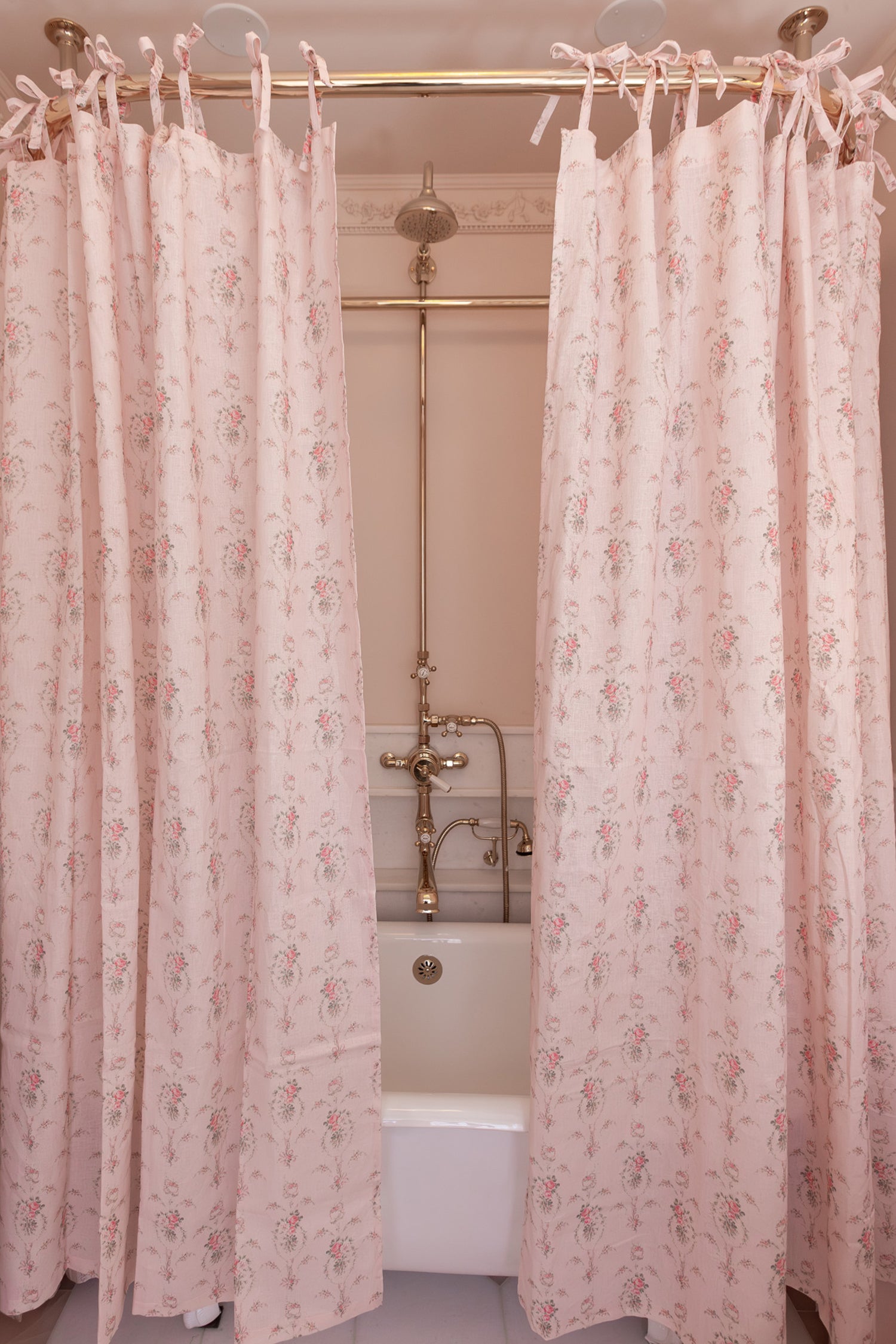 Designed from linen and cotton, its the perfect vintage-inspired shower curtain featuring a pink floral print across the back of a baby pink shower curtain. 