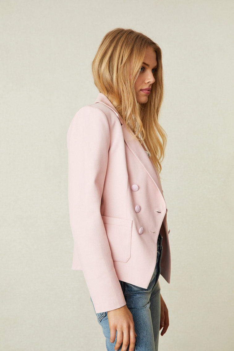 Side image of model wearing pink double breasted blazer