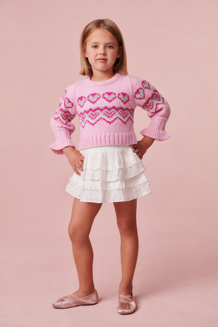 Ultra-soft plush pink knit stitched sweater with heart detailing.