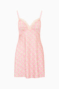 Pink slip dress with a subtle pattern on a white background
