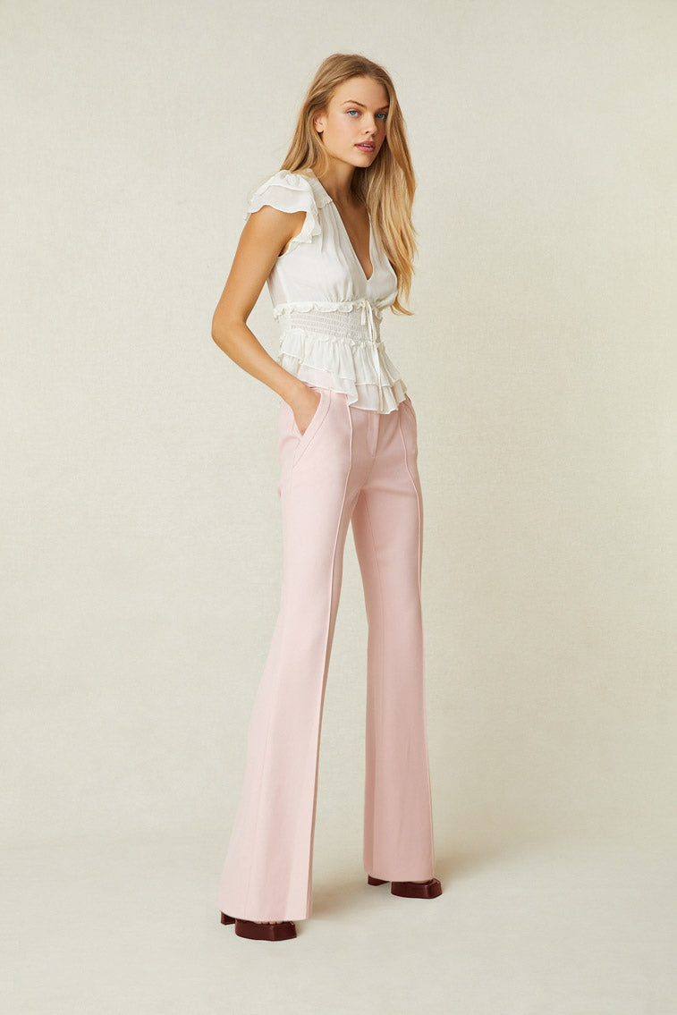 Model wearing light pink flare trouser pants