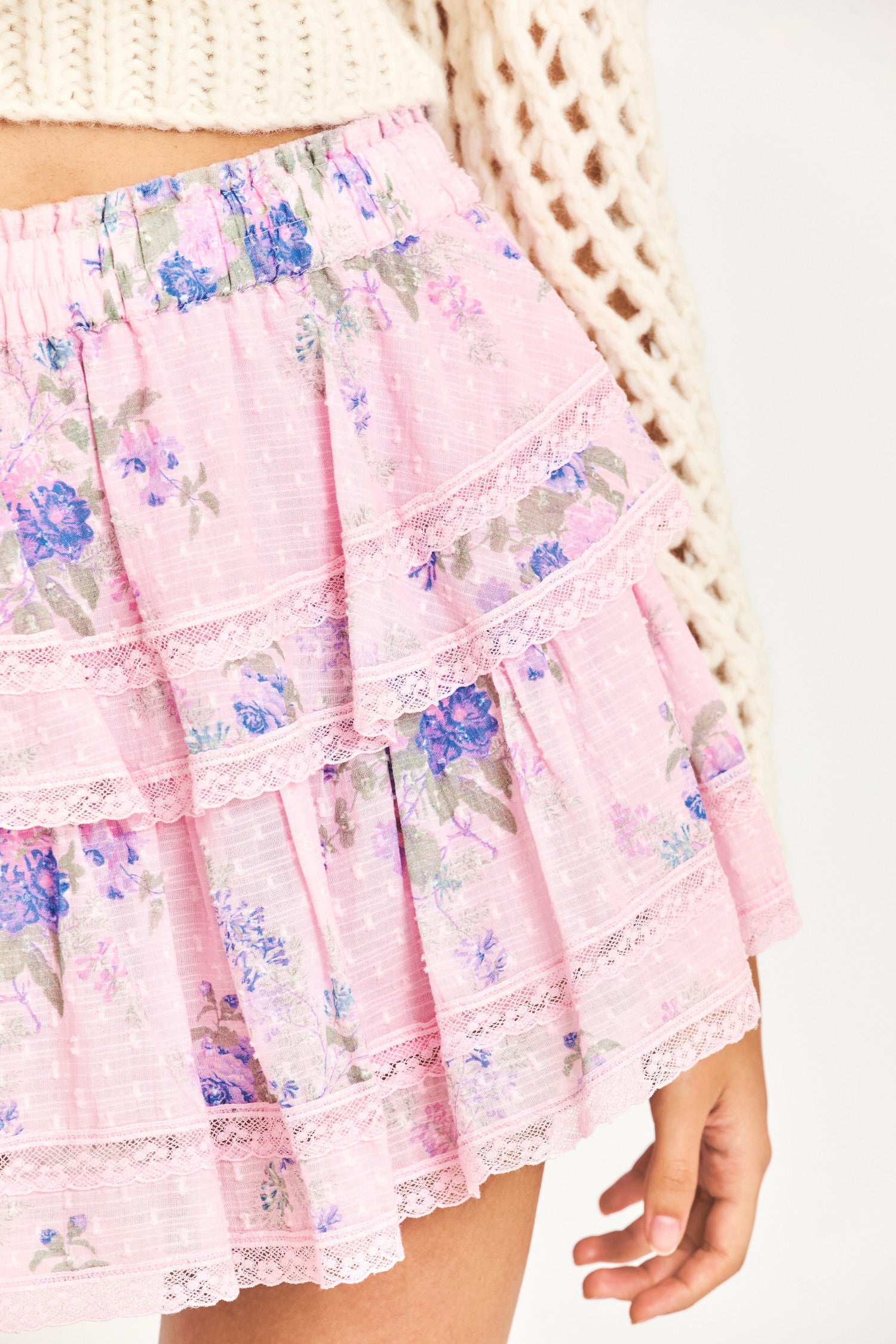  The Ruffle Mini skirt now comes with a soft pink color, blue heirloom bouquet print flowers, intricate inset lace trim, and all-over pin tuck details. It features an elastic waistband and tiered ruffles. 