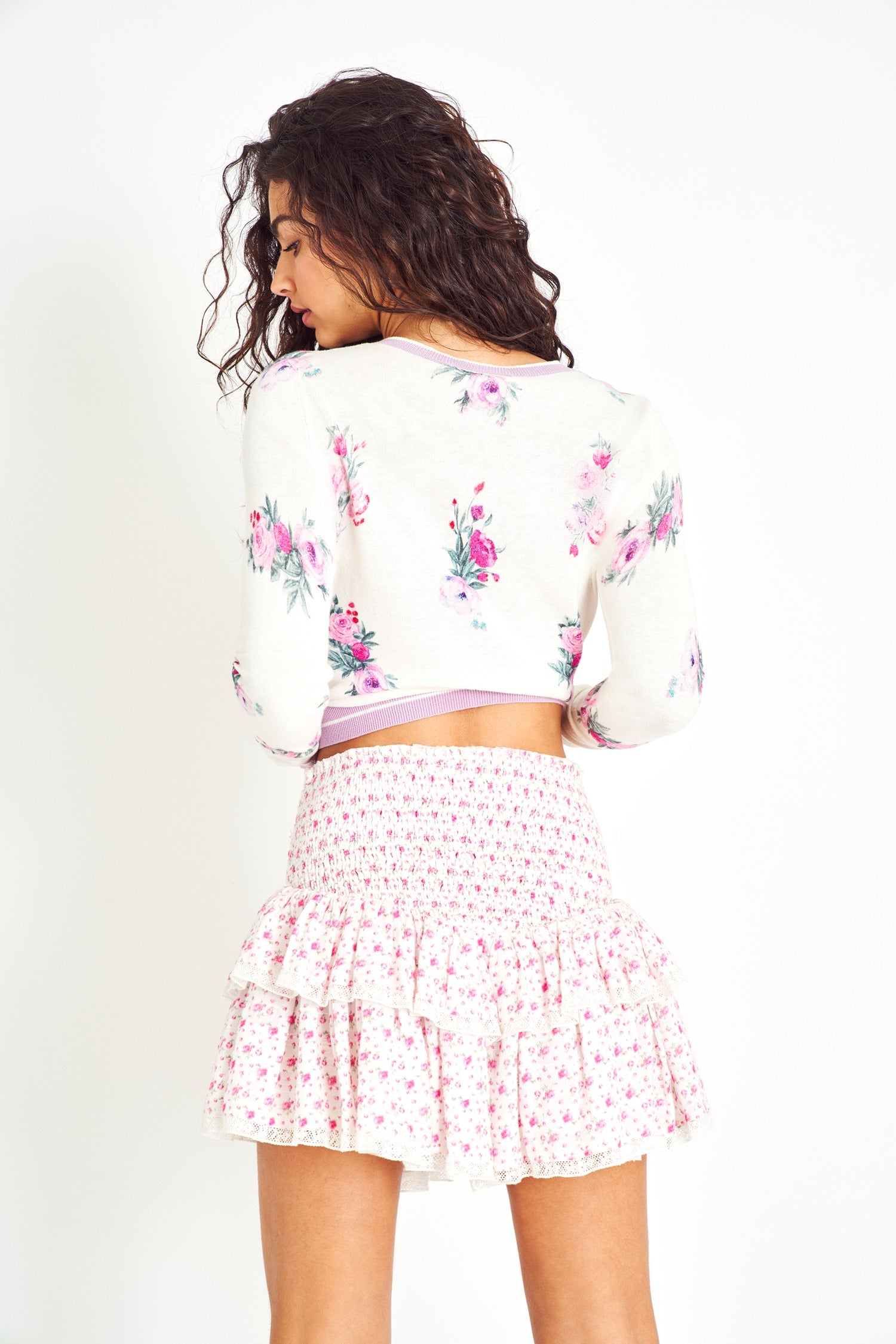 Back image of model wearing Stone Mini Skirt in Poppy Pink