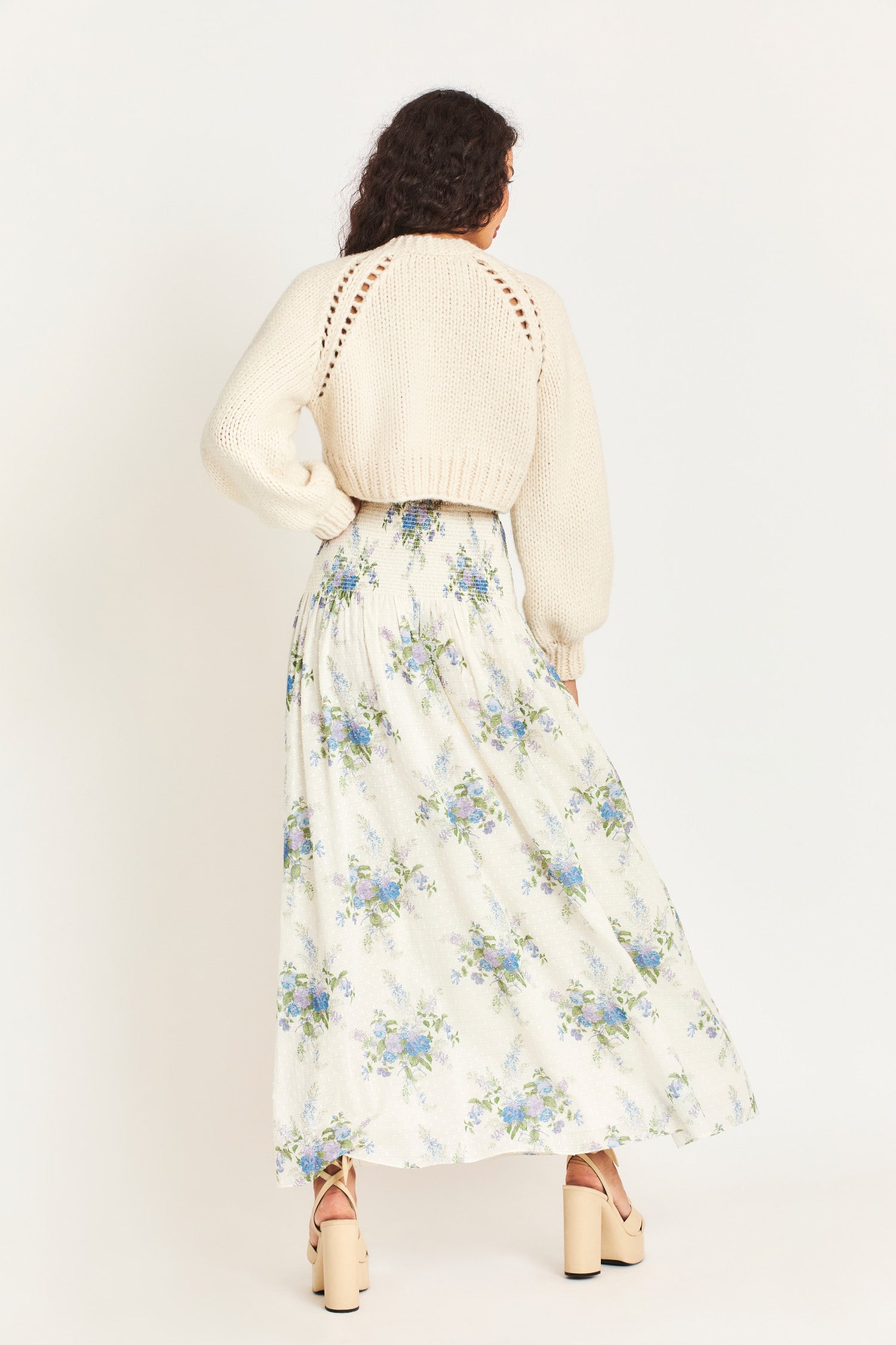 Falune Maxi skirt features an heirloom bouquet on a soft, textured white dot fabric. It has a smocked hip yoke and an added sleep for sexiness