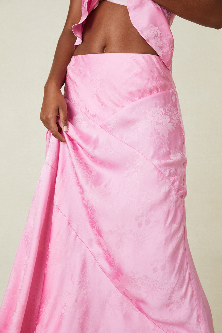 Close up image detailing seams and fabric detail on pink silk maxi skirt