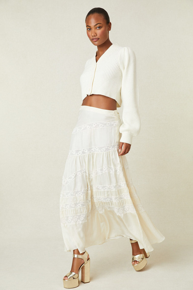 Model wearing white silk maxi skirt with lace panels