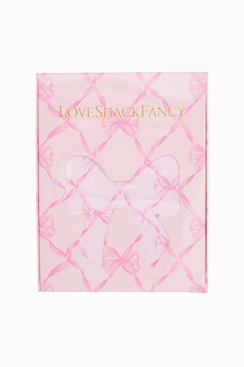 Product packaging with 'LOVE SHACK FANCY' branding on a pink and white patterned background