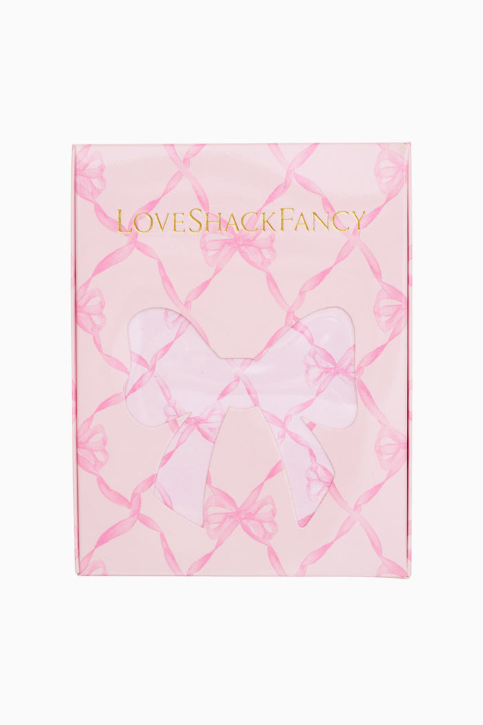 Product packaging with 'LOVE SHACK FANCY' branding on a pink and white patterned background