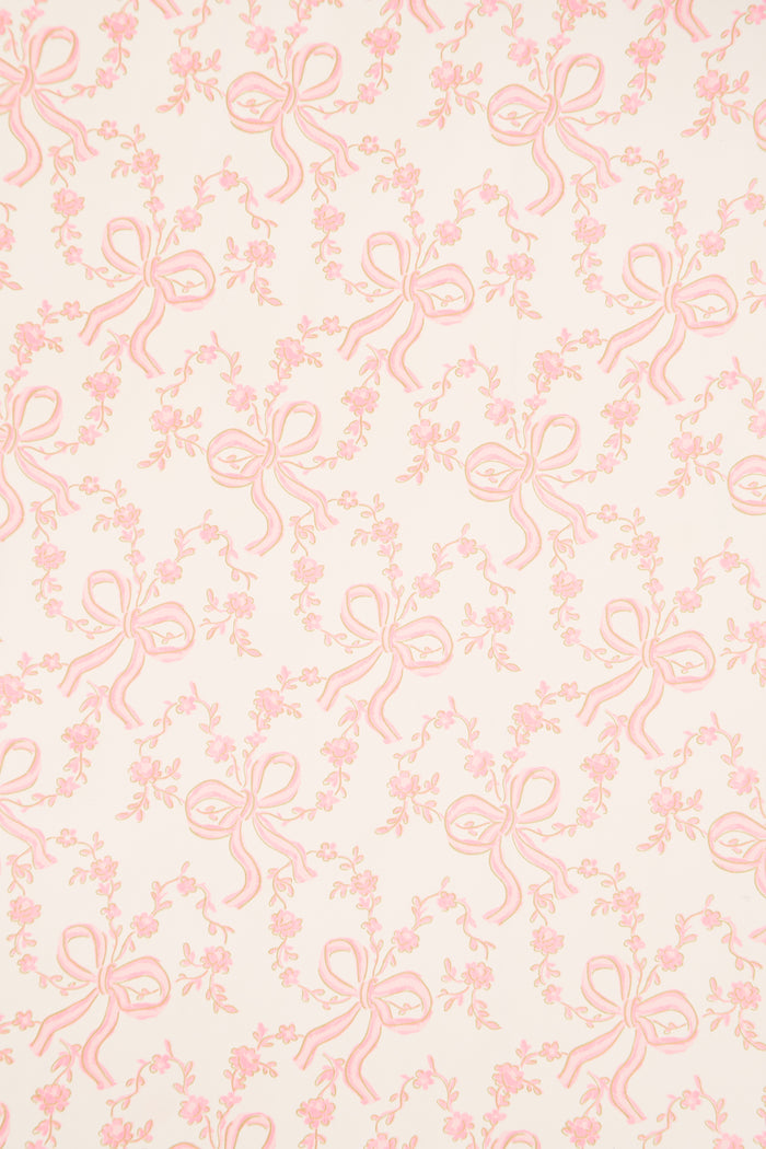Light pink gift wrap paper with repeating bow and floral line design
