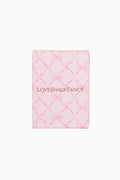 Pink quilted product with 'LOVE SHACK FANCY' branding on a white background