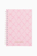 Pink quilted notebook with 'LOVE SHACK FANCY' branding on a white background