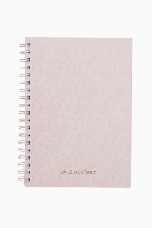 Pink textured notebook with 'LOVE SHACK FANCY' branding on a white background