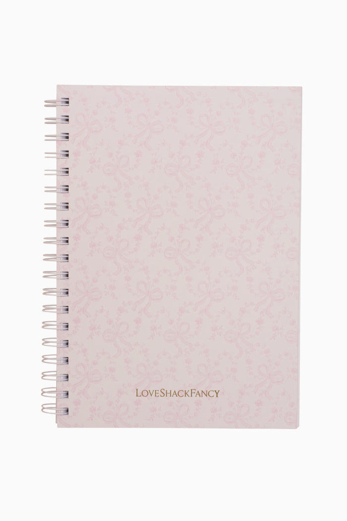 Pink textured notebook with 'LOVE SHACK FANCY' branding on a white background