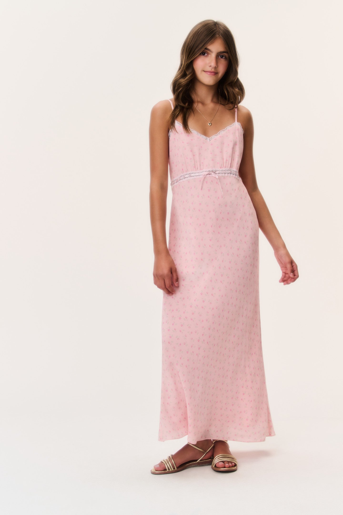 Women sitting in grass field wearing LoveShackFancy Slip Dresses