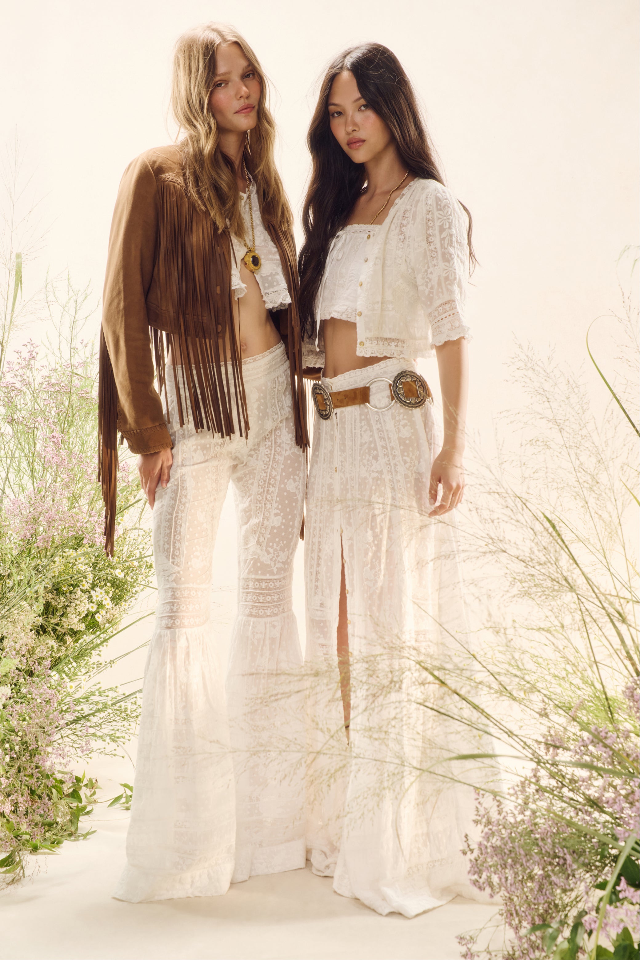 Women sitting in grass field wearing LoveShackFancy Slip Dresses