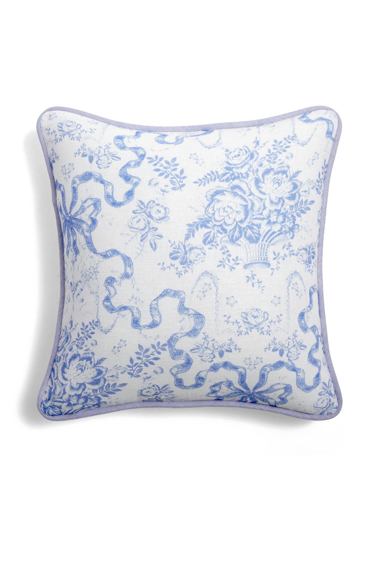 Throw pillow with a blue floral and bow print.