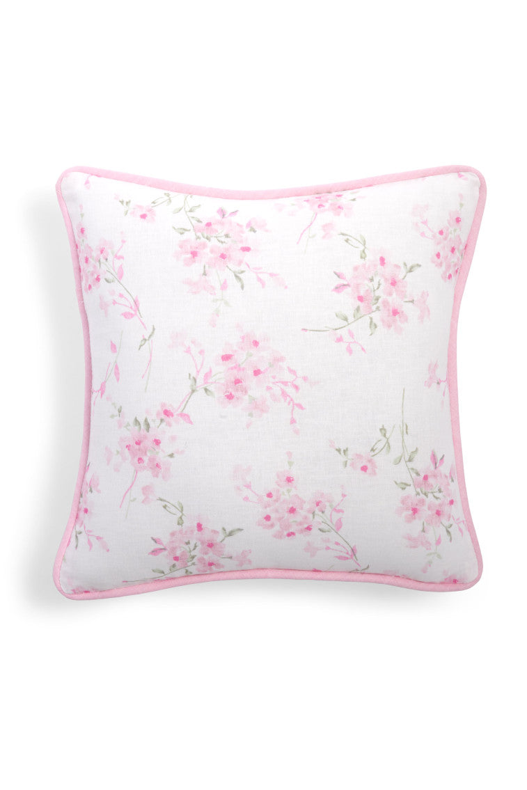 White throw pillow with a pink  floral print.