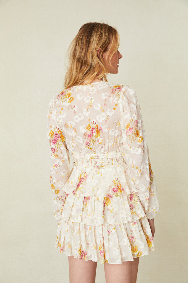 Floral printed mini that features long blouson sleeves and a multi-tiered skirt.