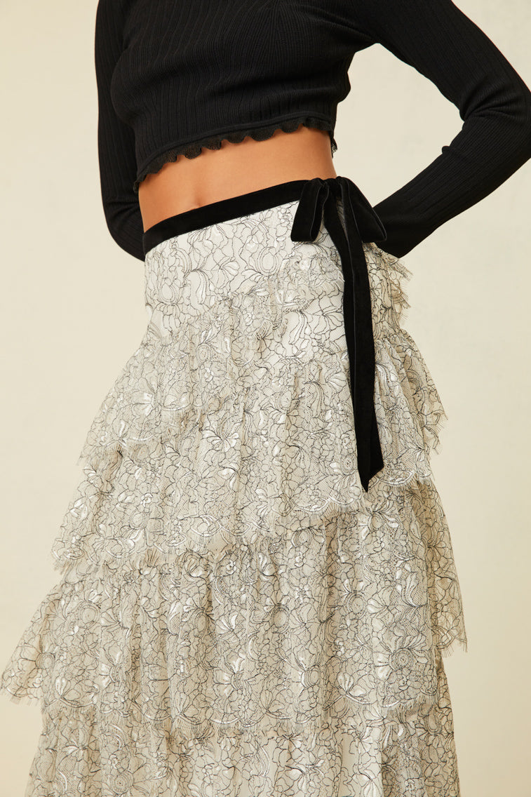 Midi skirt features multi-tiered layers of delicate French lace and a velvet tape ribbon.