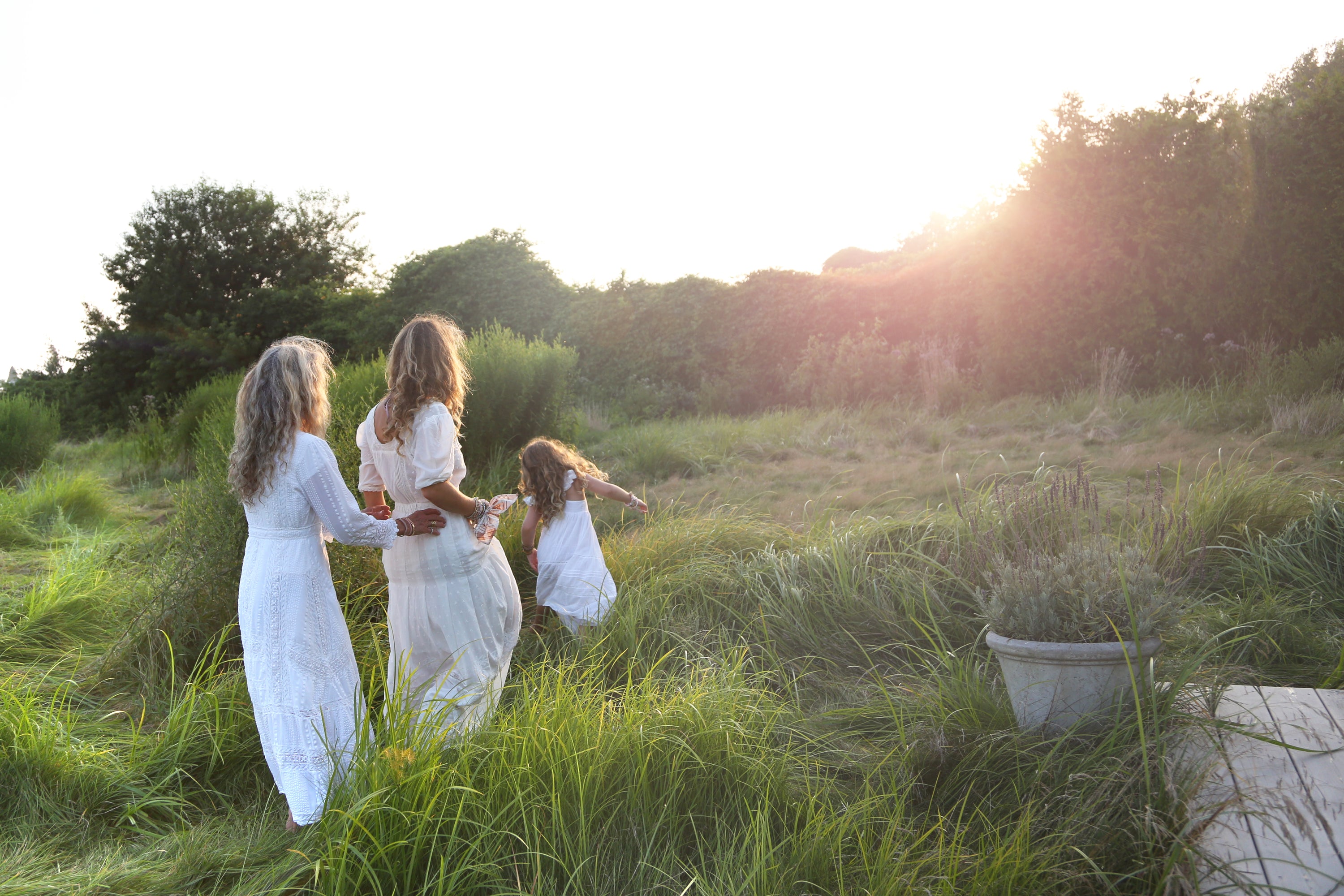 Founder and creative director Rebecca Hessel Cohen and her daughters in a grassy field