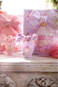 Pink mini eau de parfum bottle with floral bow and gold cap, set gift box beside it