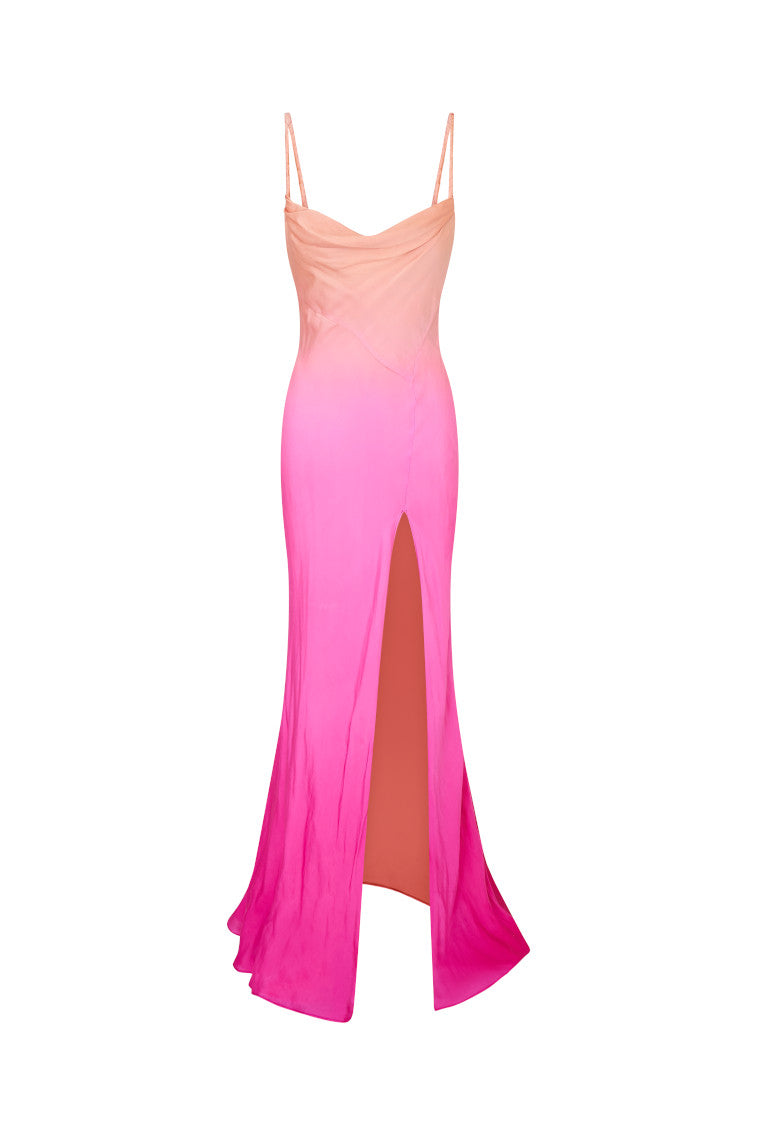 Maxi dress featuring a gorgeous ombré coloring that flows from a bright coral at the top to a fuchsia at the bottom. With a bias cut, this dress begins with twisted chiffon straps and a cowl neck before descending into the figure-hugging bodice that releases into a long skirt with a high slit.