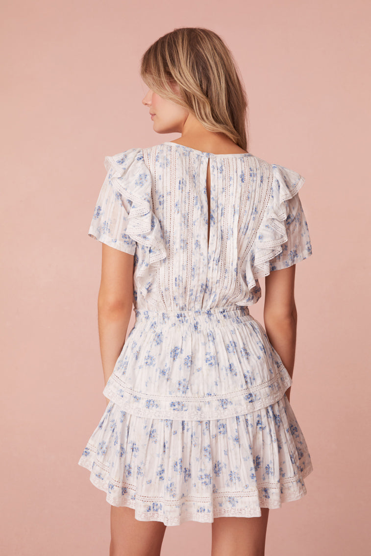 Mini dress with double ruffled flutter sleeves, which cascade down the front and back of the body to highlight the elasticated waist. Intricate custom lace panels are inset and trim the skirt’s flounces.