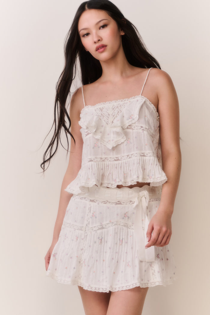 Woman wearing ruffle camisole and matching skirt