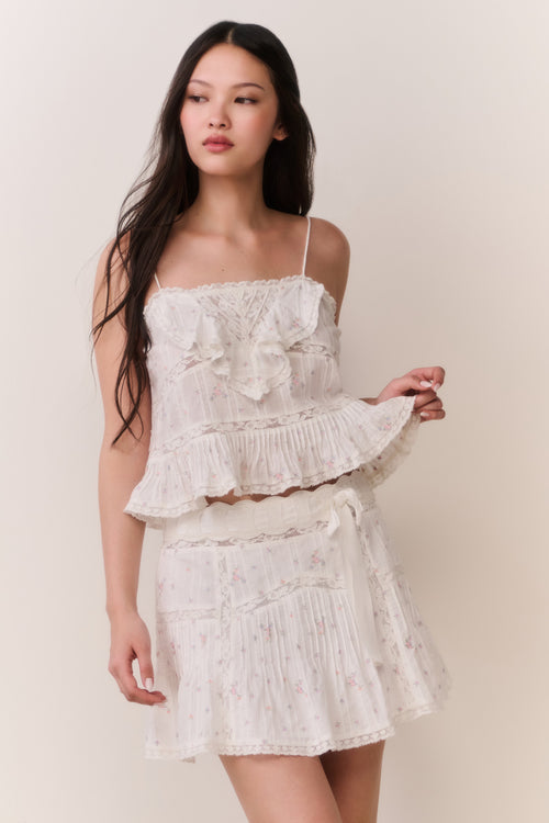 Woman wearing ruffle camisole and matching skirt