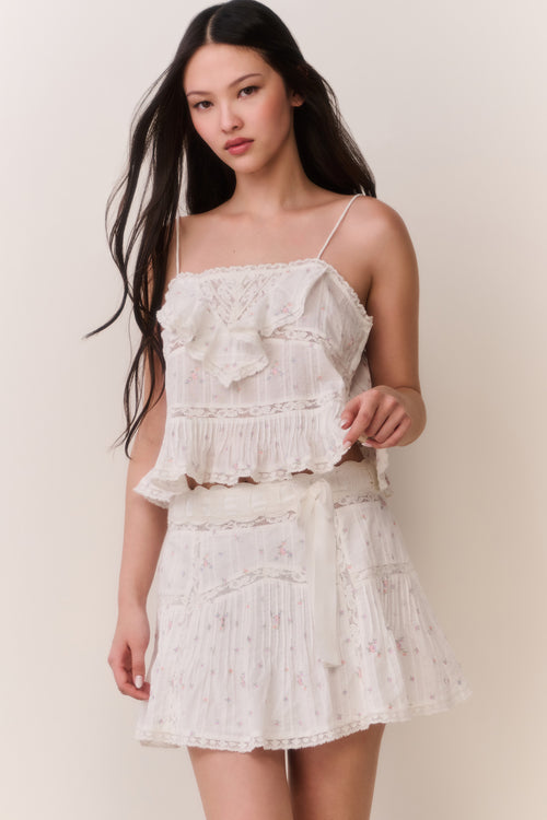 Woman wearing ruffle camisole and matching skirt