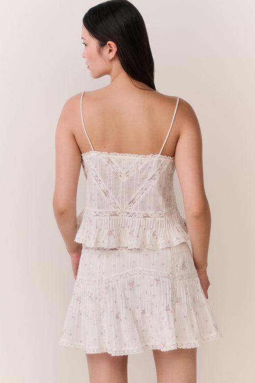 Woman wearing ruffle camisole and matching skirt