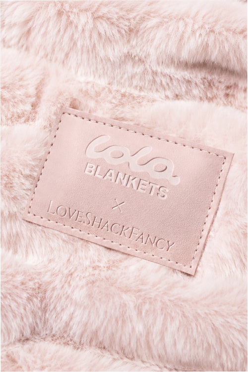 Close-up of throw blanket in petal pink textured with a soft, frosted finish