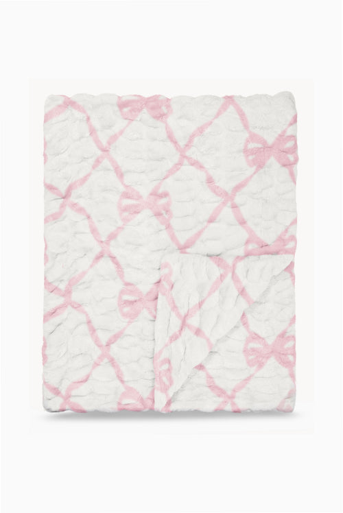 Folded fleece-style blanket with pink bow lattice pattern on white background