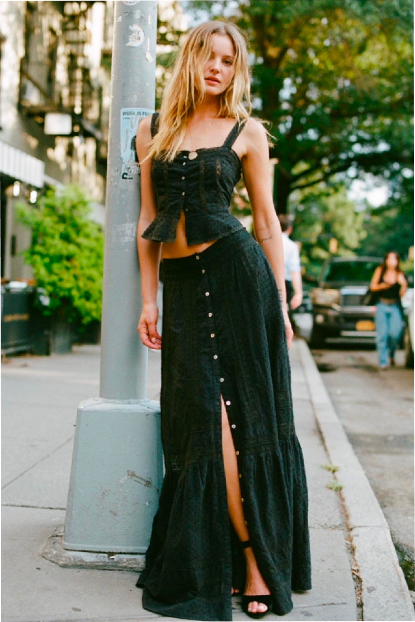 Women sitting in grass field wearing LoveShackFancy Slip Dresses