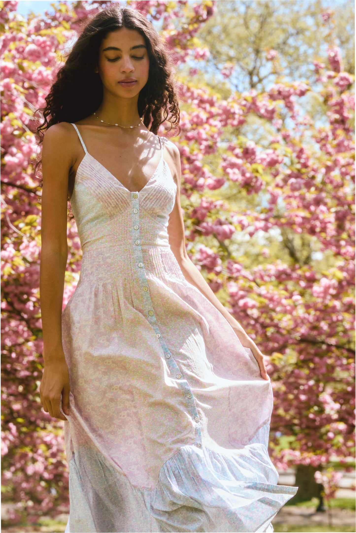 Women sitting in grass field wearing LoveShackFancy Slip Dresses