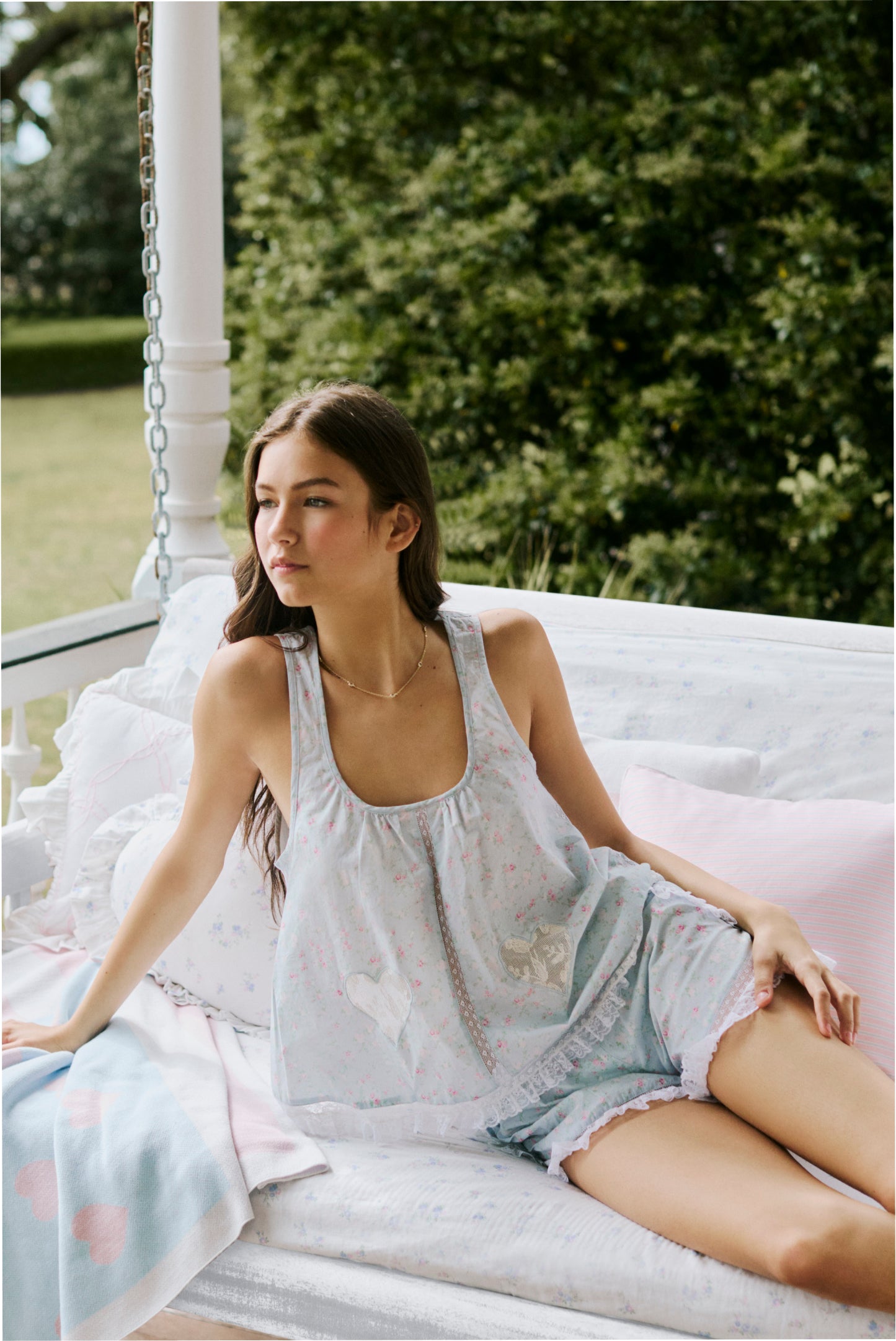 Women sitting in grass field wearing LoveShackFancy Slip Dresses