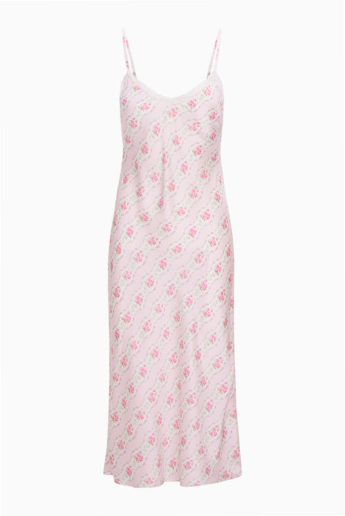 White slip dress with pink floral pattern on a white background