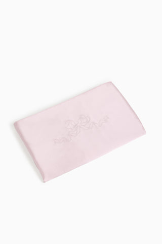 Pink folded pillow case with bow embroidery on a white background