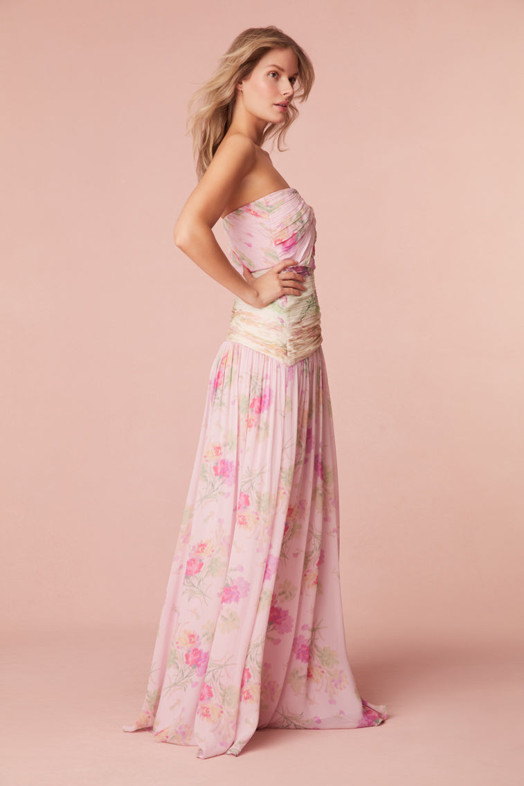 Floral gown featuring color-blocking pastels and a strapless neckline. The dress includes a structured bodice for support, lightweight ruching, and gripping tape at the opening edge of the neckline. A keyhole detail sits at center front.